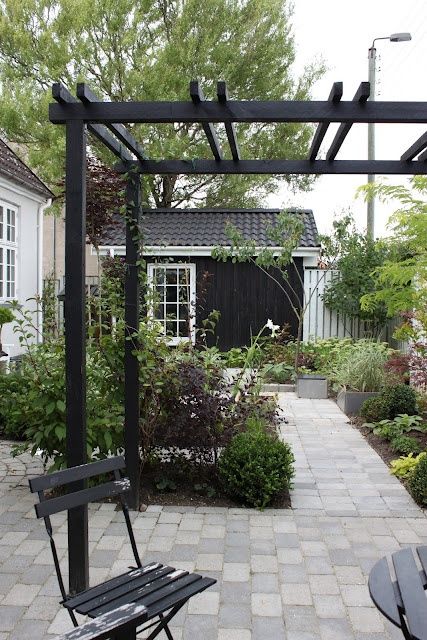 black pergola in garden